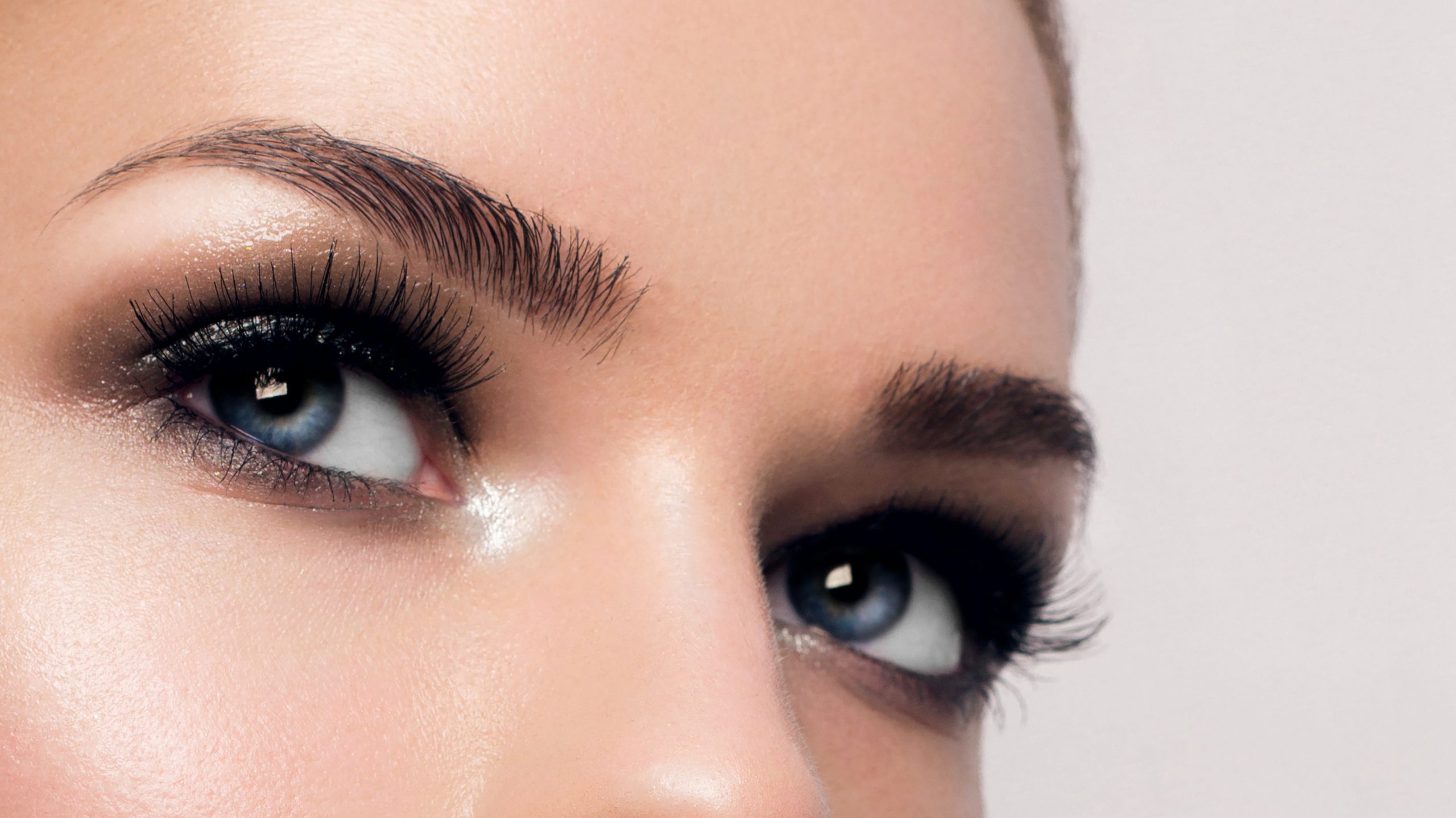 Macro shot of woman's beautiful eye with extremely long eyelashes. Sexy view, sensual look. Female eye with long eyelashes